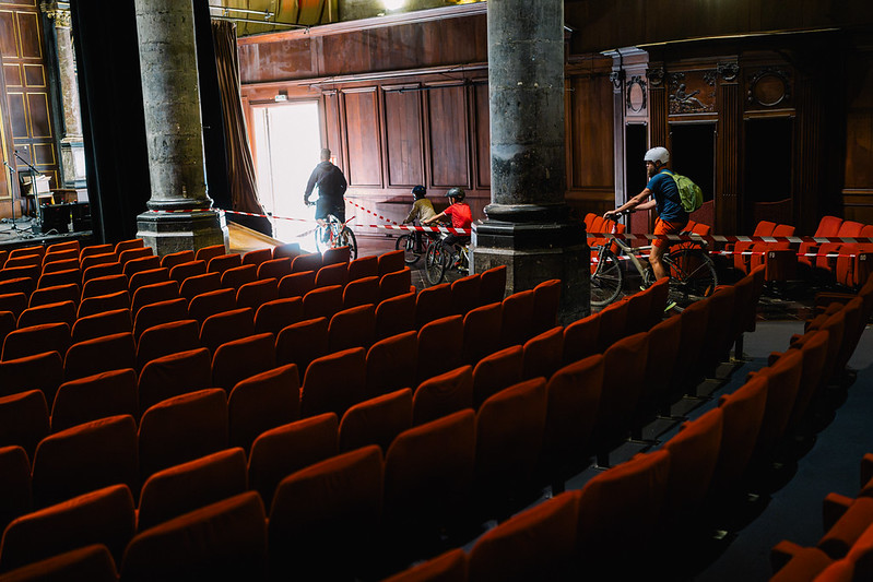 Les cyclistes dans les fauteuils rouges du théâtre